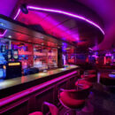 Main bar and social space inside SwingerForYou Budapest, where couples gather to chat, enjoy drinks, and meet throughout the evening.