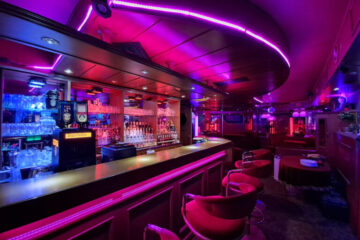 Main bar and social space inside SwingerForYou Budapest, where couples gather to chat, enjoy drinks, and meet throughout the evening.