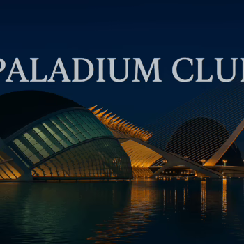 Nighttime view of Valencia’s City of Arts and Sciences with bold Paladium Club text overlay, reflecting in the water with elegant architectural lighting
