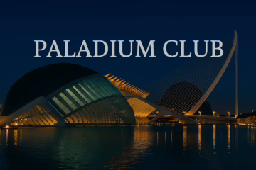 Nighttime view of Valencia’s City of Arts and Sciences with bold Paladium Club text overlay, reflecting in the water with elegant architectural lighting