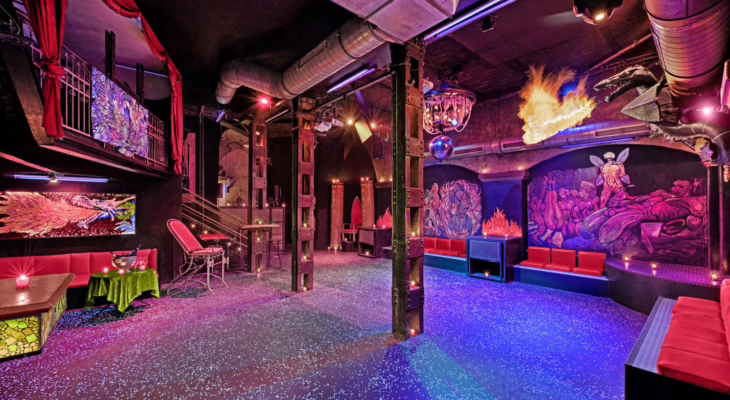 Interior of KitKat Club Berlin showing red seating, fetish-themed decor, and neon lights, illustrating the unique atmosphere described in the KitKat Club Review.