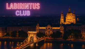 Illuminated nighttime view of Budapest with the Chain Bridge and St. Stephen’s Basilica glowing over the Danube, featuring the text “Labirintus Club” — representing the vibrant and discreet atmosphere of the newly opened Labirintus Swinger Club in the city.