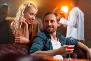 Inside a stylish swinger club lounge with warm lights and relaxed guests, showing what to expect when you’re nervous before a swinger club visit.