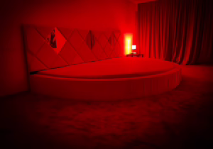 Red-lit private room with round bed at Bad Romance Bucharest swinger club