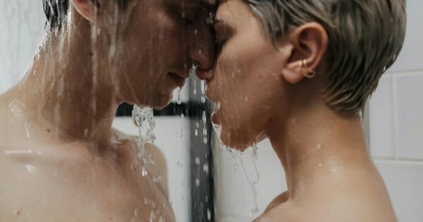 Couple sharing an intimate moment under a shower, symbolizing trust, consent, and emotional closeness in wife sharing in practice