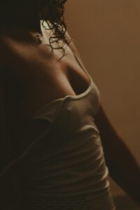 Close-up of woman in soft lighting symbolizing trust, vulnerability, and double penetration exploration in lifestyle dynamics
