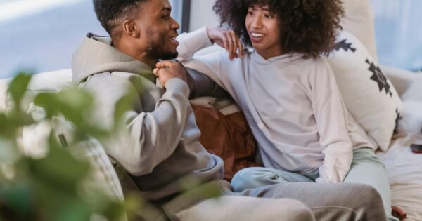 Couple sitting on a couch talking openly, representing communication and trust when discussing swinger couple goals and fantasies. Small SEO tip for WordPress (important): When uploading, also set: Caption (optional but good for engagement) Example: Open communication and trust are the foundation of healthy swinger couple goals. Description (WordPress media field) You can paste the same text as the alt text or a slightly expanded version. If you want, I can also show you which one should be the featured image and why, because one of these will perform much better for clicks from Google Discover and Pinterest-style previews.