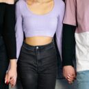 Three people holding hands representing ethical non-monogamy and polyamory relationship dynamics