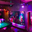 Colorful bar and entrance area at Lovekino with neon lighting and social spaces