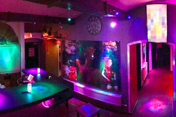 Colorful bar and entrance area at Lovekino with neon lighting and social spaces