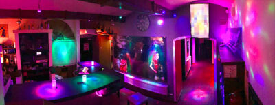 Colorful bar and entrance area at Lovekino with neon lighting and social spaces