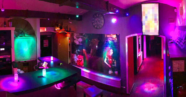 Colorful bar and entrance area at Lovekino with neon lighting and social spaces