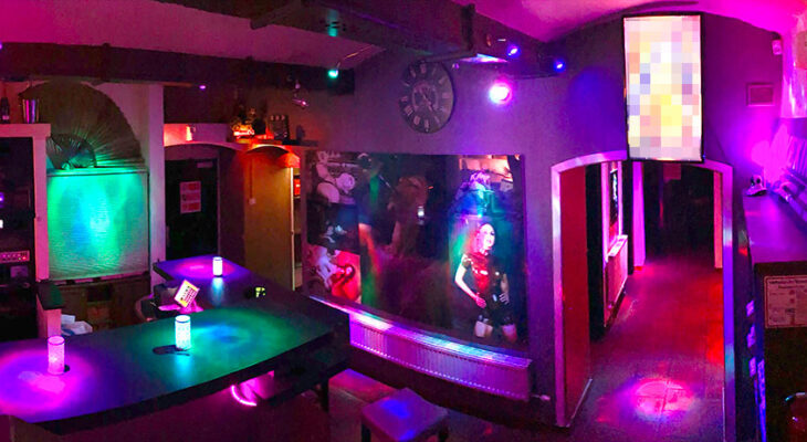 Colorful bar and entrance area at Lovekino with neon lighting and social spaces
