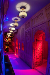 Decorative hallway inside Moon City Paris with arches, soft lighting, and themed interior design