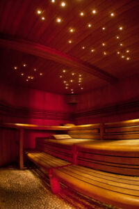 Sauna at Moon City Paris with wooden seating and warm lighting for relaxation between experiences