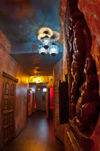 Detailed interior of Moon City Paris showing artistic walls, warm lighting, and immersive design elements