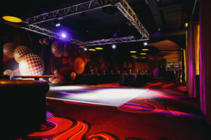 Dance floor at Swinger Club Paradiso with colorful lighting and open space for social interaction