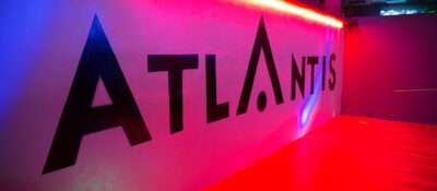 Stylish interior hallway and illuminated ATLANTIS signage inside the club