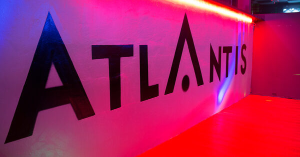 Stylish interior hallway and illuminated ATLANTIS signage inside the club