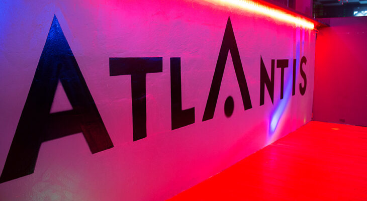 Stylish interior hallway and illuminated ATLANTIS signage inside the club