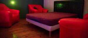 Private play room inside ATLANTIS Rivesaltes with soft lighting and lounge seating
