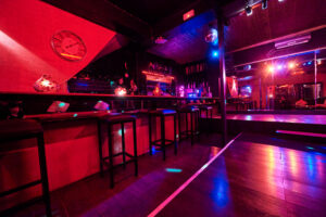 Elegant bar and social area inside Club Cocoon Brussels swinger club with atmospheric lighting