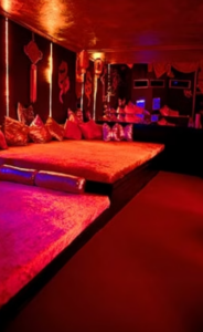 Comfortable private play room inside Experior Beach with intimate lighting and lounge seating