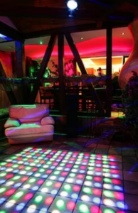 Colorful social and lounge area inside Experior Beach designed for conversation and nightlife atmosphere