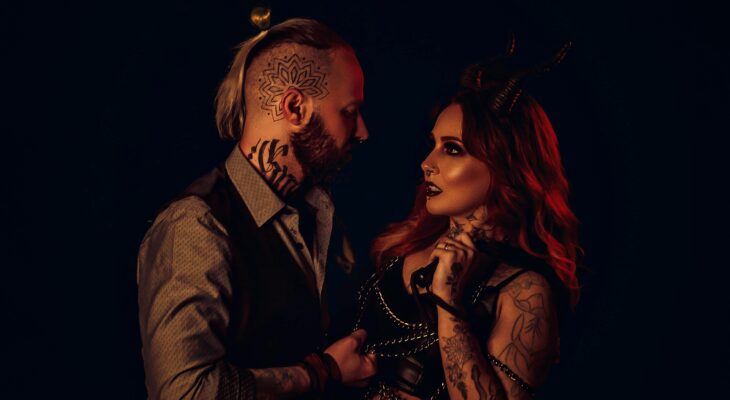 Couple in dark fetish-inspired styling representing the emotional overlap between swinger and fetish culture