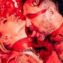 Couple wearing red leather collars and chains sharing an intimate moment, capturing the sensual, fetish-inspired atmosphere of Kinky Galore Vienna.