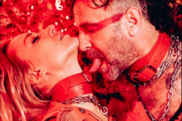 Couple wearing red leather collars and chains sharing an intimate moment, capturing the sensual, fetish-inspired atmosphere of Kinky Galore Vienna.